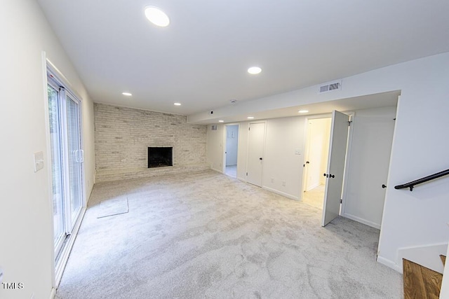 2309 Bertie Dr, Raleigh, NC 27610 - unfurnished living room with recessed lighting, light colored carpet, and a brick fireplace