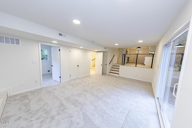 2309 Bertie Dr, Raleigh, NC 27610 - below grade area with light colored carpet, stairway, and recessed lighting