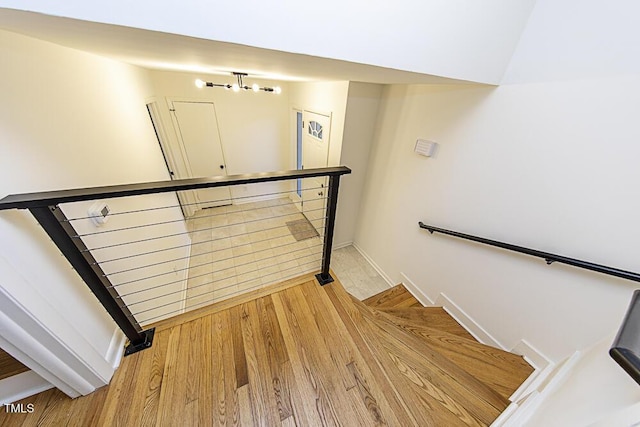 2309 Bertie Dr, Raleigh, NC 27610 - stairs featuring wood finished floors and baseboards