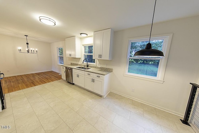 2309 Bertie Dr, Raleigh, NC 27610 - kitchen with a chandelier, plenty of natural light, and white cabinetry