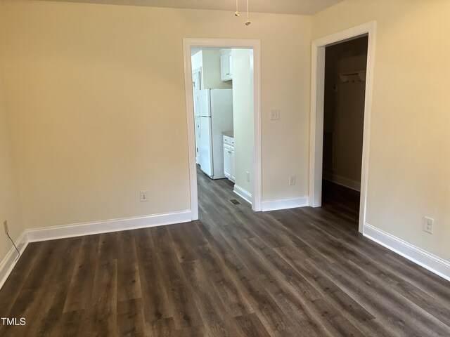 12719 S St, Whitakers, NC 27891 - spare room featuring dark wood-style flooring and baseboards