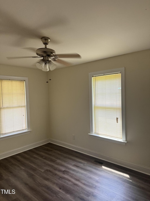 12719 S St, Whitakers, NC 27891 - empty room with plenty of natural light, dark wood-style floors, and a ceiling fan