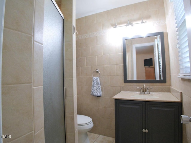 503 N Glen Dr, Raleigh, NC 27609 - bathroom featuring tile walls, vanity, a stall shower, and tile patterned flooring