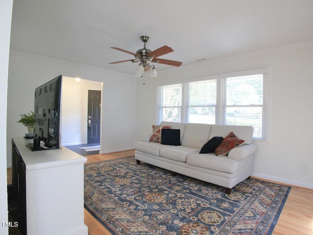 503 N Glen Dr, Raleigh, NC 27609 - living room with light wood finished floors, a ceiling fan, and crown molding