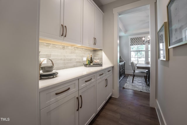 249 Dona Dr, Carthage, NC 28327 - kitchen with dark wood-style flooring, white cabinets, light countertops, tasteful backsplash, and a chandelier