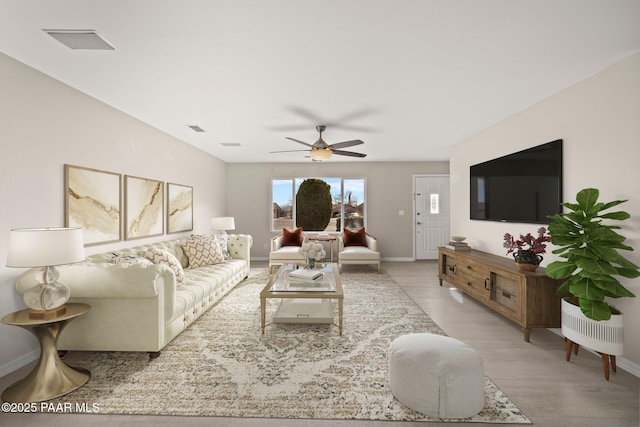 living room with ceiling fan and light wood-type flooring