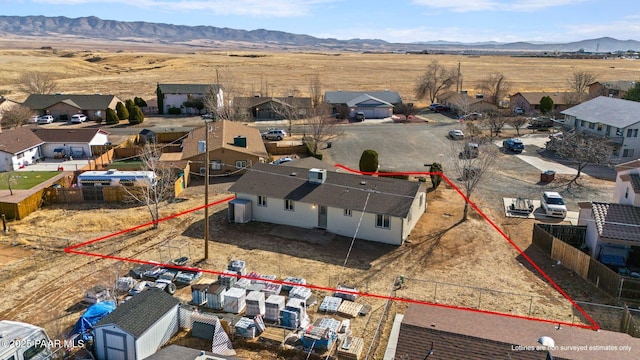 birds eye view of property featuring a mountain view