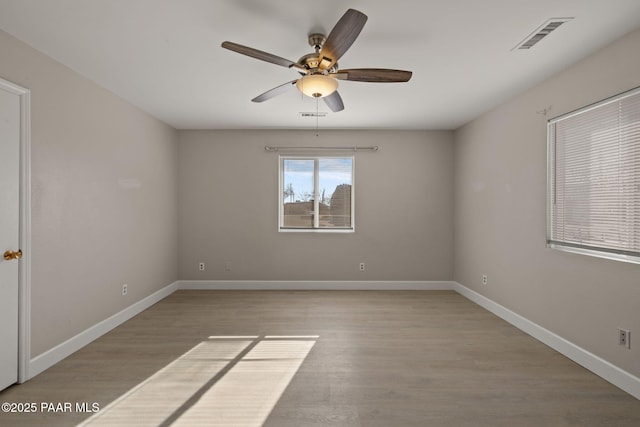 empty room featuring ceiling fan and light hardwood / wood-style floors