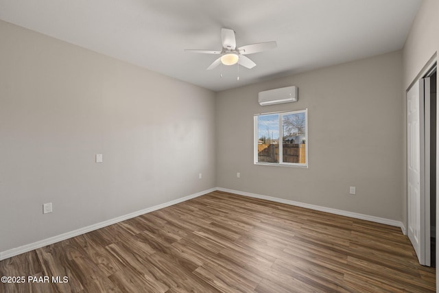 unfurnished bedroom with dark hardwood / wood-style flooring, ceiling fan, a wall unit AC, and a closet