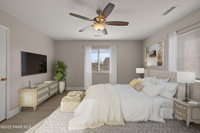 bedroom with hardwood / wood-style floors and ceiling fan