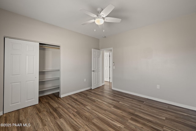 unfurnished bedroom featuring ceiling fan, dark hardwood / wood-style flooring, and a closet