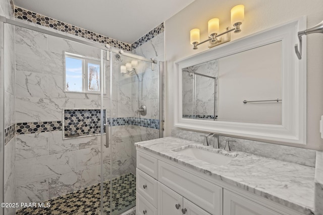 bathroom with vanity and a shower with door