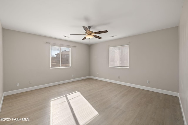 empty room featuring ceiling fan and light wood-type flooring