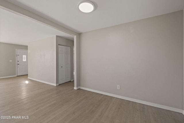 unfurnished room with light wood-type flooring