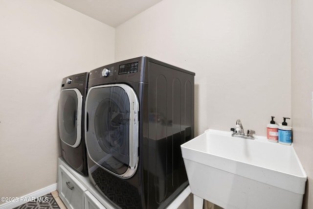 7300 Butte Vis, Prescott Valley, AZ 86315 - laundry area with baseboards, washing machine and dryer, a sink, and laundry area