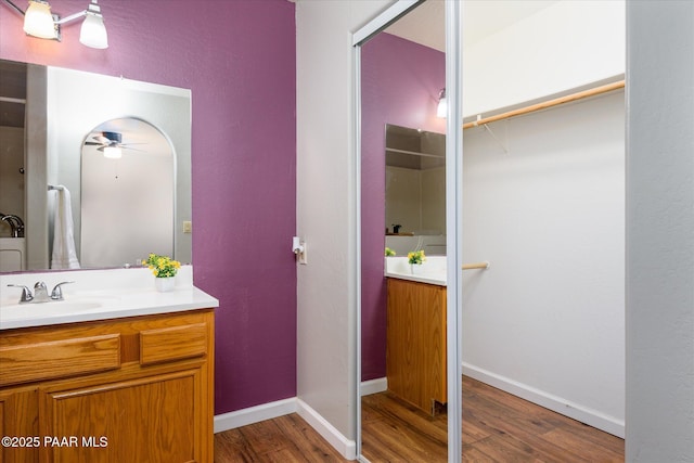 13819 S Bluebird Ln, Mayer, AZ 86333 - full bathroom featuring vanity, wood finished floors, a ceiling fan, and a walk in closet
