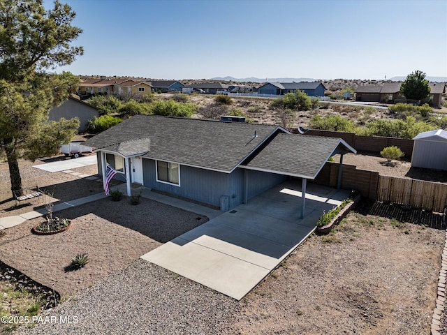 13819 S Bluebird Ln, Mayer, AZ 86333 - single story home featuring concrete driveway, a carport, roof with shingles, and a residential view