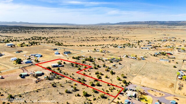 bird's eye view featuring a rural view, a mountain view, and a desert view