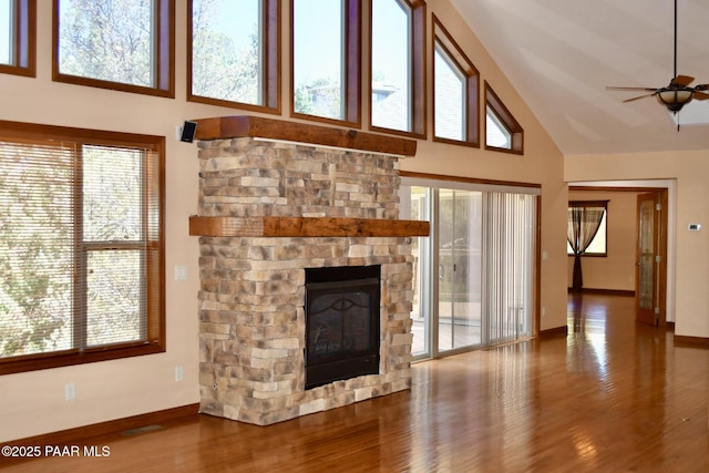 1284 Mcdonald Dr, Prescott, AZ 86303 - unfurnished living room with high vaulted ceiling, plenty of natural light, a ceiling fan, wood finished floors, and a fireplace