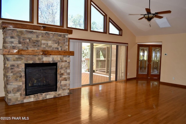 1284 Mcdonald Dr, Prescott, AZ 86303 - unfurnished living room featuring wood finished floors, high vaulted ceiling, a ceiling fan, and a fireplace