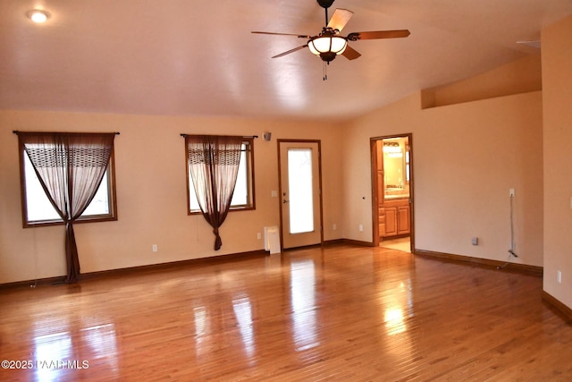 1284 Mcdonald Dr, Prescott, AZ 86303 - unfurnished living room with a ceiling fan, vaulted ceiling, light wood-style floors, and radiator