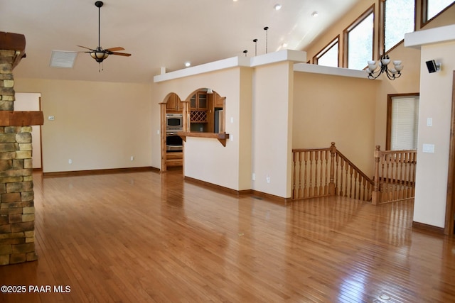 1284 Mcdonald Dr, Prescott, AZ 86303 - unfurnished living room featuring ceiling fan, light wood-type flooring, high vaulted ceiling, and arched walkways