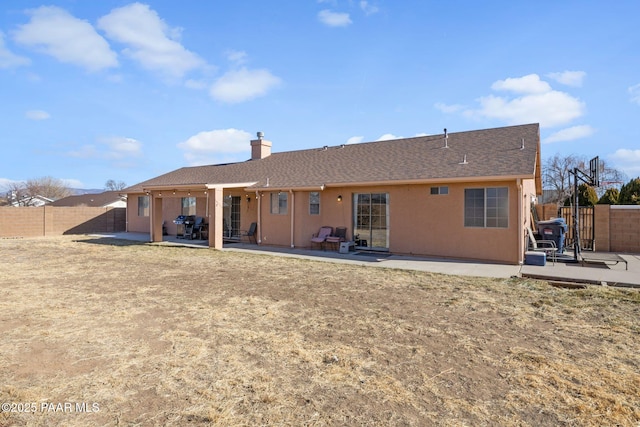 rear view of house with a patio