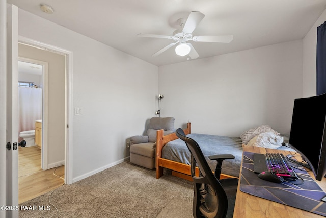 carpeted bedroom with connected bathroom and ceiling fan