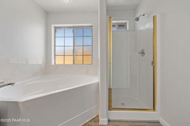 bathroom featuring hardwood / wood-style floors and separate shower and tub