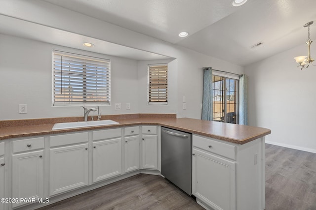 kitchen with white cabinets, stainless steel dishwasher, hanging light fixtures, and sink