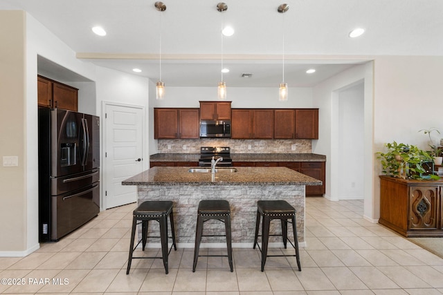 6214 Harvest Moon Ave, Prescott, AZ 86305 - kitchen featuring stainless steel microwave, fridge with ice dispenser, tasteful backsplash, a breakfast bar, and light tile patterned floors