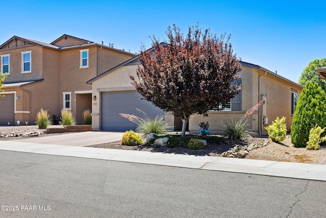 6214 Harvest Moon Ave, Prescott, AZ 86305 - view of front of house with stucco siding, concrete driveway, and a garage