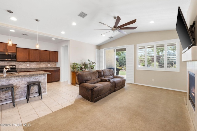 6214 Harvest Moon Ave, Prescott, AZ 86305 - living room featuring a ceiling fan, recessed lighting, vaulted ceiling, light tile patterned floors, and light carpet