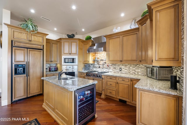 791 N Creekside Dr, Prescott, AZ 86303 - kitchen featuring built in appliances, beverage cooler, wall chimney exhaust hood, light stone counters, and a kitchen island with sink