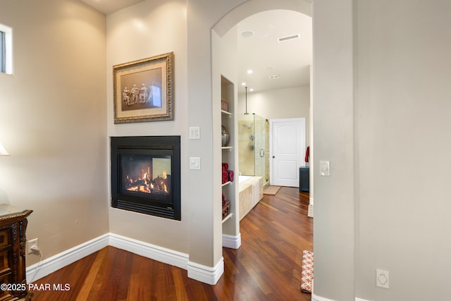 791 N Creekside Dr, Prescott, AZ 86303 - corridor with dark wood-type flooring, built in shelves, and arched walkways