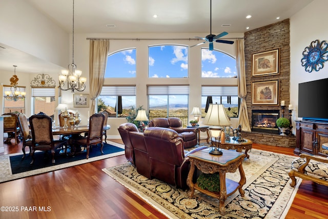 791 N Creekside Dr, Prescott, AZ 86303 - living area featuring a chandelier, a large fireplace, a high ceiling, wood finished floors, and a ceiling fan