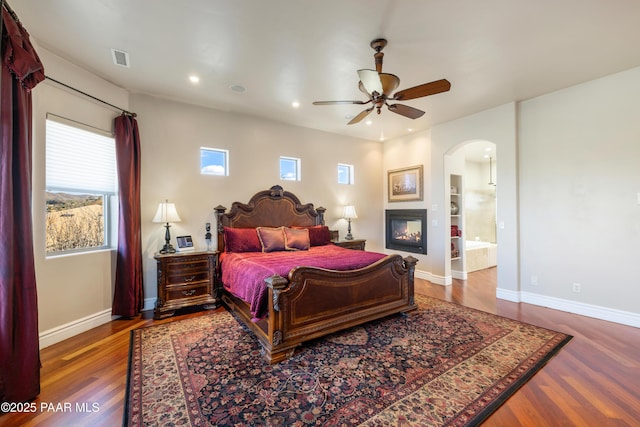 791 N Creekside Dr, Prescott, AZ 86303 - bedroom with arched walkways, wood finished floors, recessed lighting, and connected bathroom