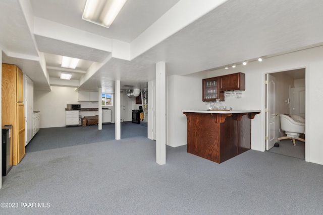 basement with carpet flooring and indoor bar