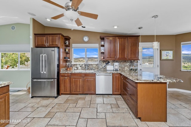 kitchen featuring sink, kitchen peninsula, lofted ceiling, decorative light fixtures, and appliances with stainless steel finishes