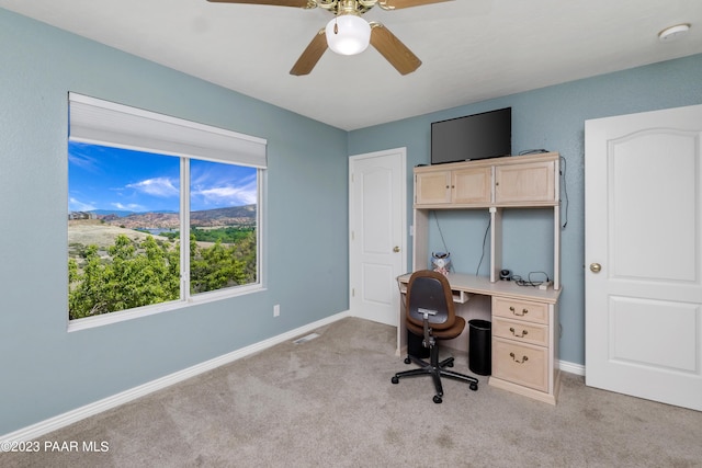 carpeted office with ceiling fan