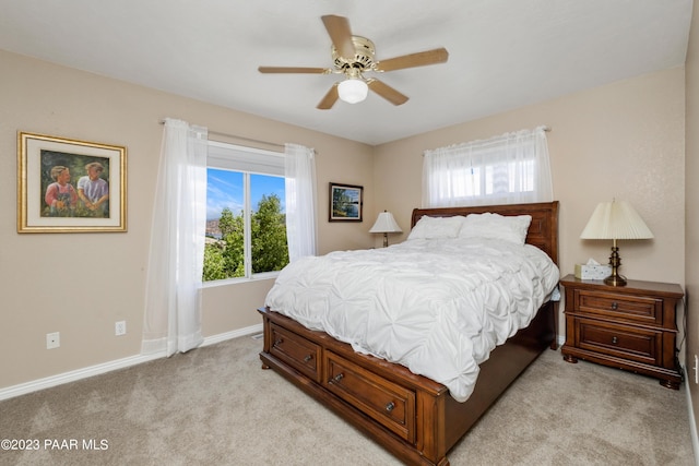 bedroom with ceiling fan and light colored carpet