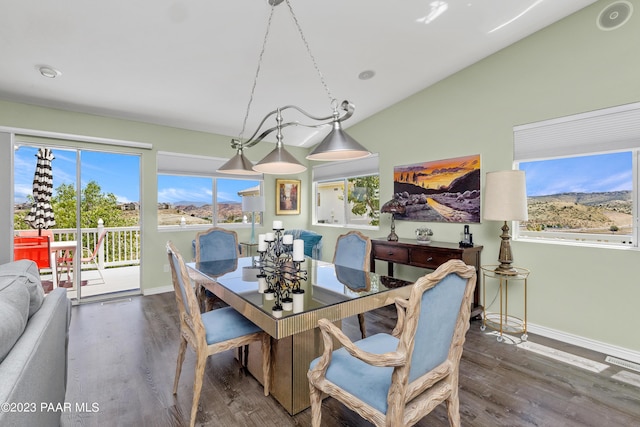 dining area with dark hardwood / wood-style floors and vaulted ceiling