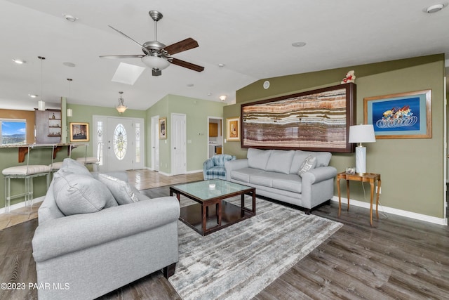 living room with ceiling fan, lofted ceiling, and hardwood / wood-style flooring