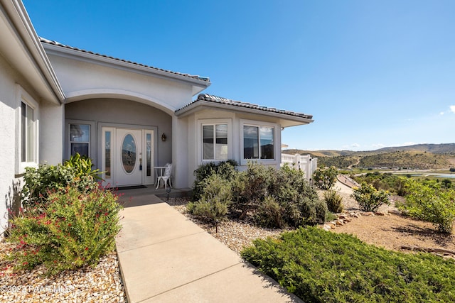 view of exterior entry with a mountain view