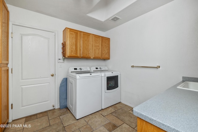 laundry area featuring cabinets and separate washer and dryer