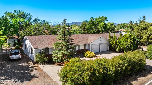 7869 Spouse Dr, Prescott Valley, AZ 86314 - view of front of home featuring an attached garage and a shingled roof