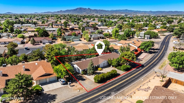 7869 Spouse Dr, Prescott Valley, AZ 86314 - aerial view of residential area with property boundaries highlighted and a mountain backdrop