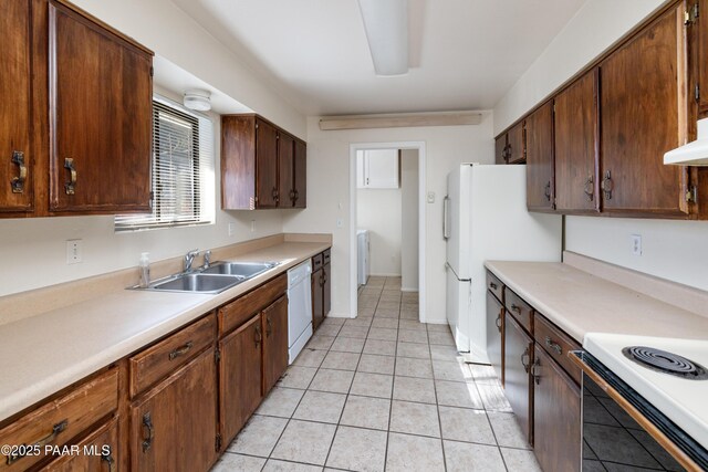 7869 Spouse Dr, Prescott Valley, AZ 86314 - kitchen with light tile patterned floors, white appliances, light countertops, washer / dryer, and range hood