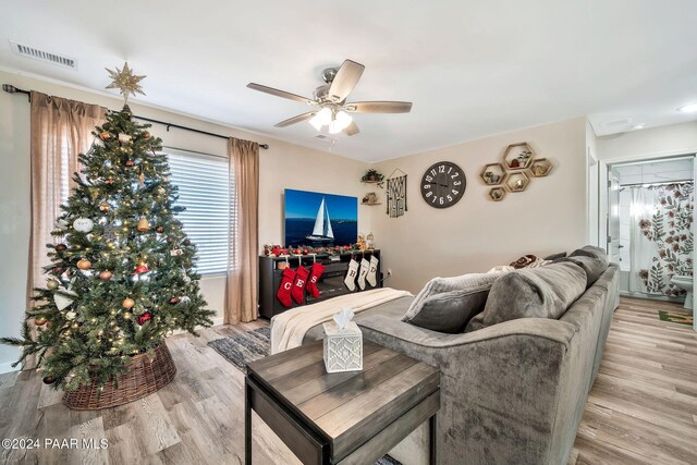 living room featuring light wood-type flooring and ceiling fan