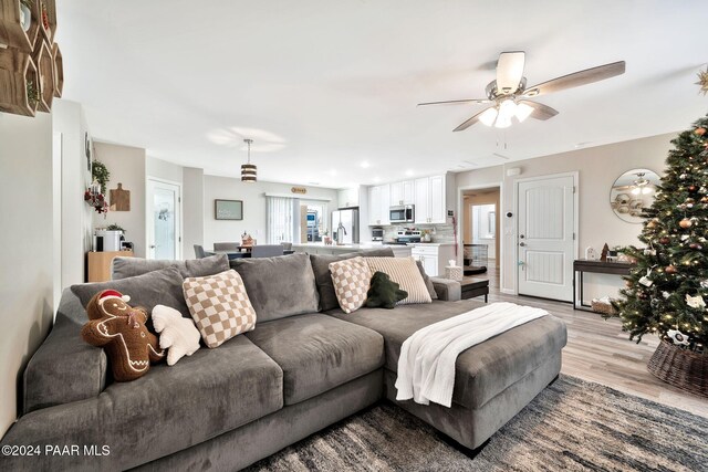 living room with ceiling fan and light hardwood / wood-style floors